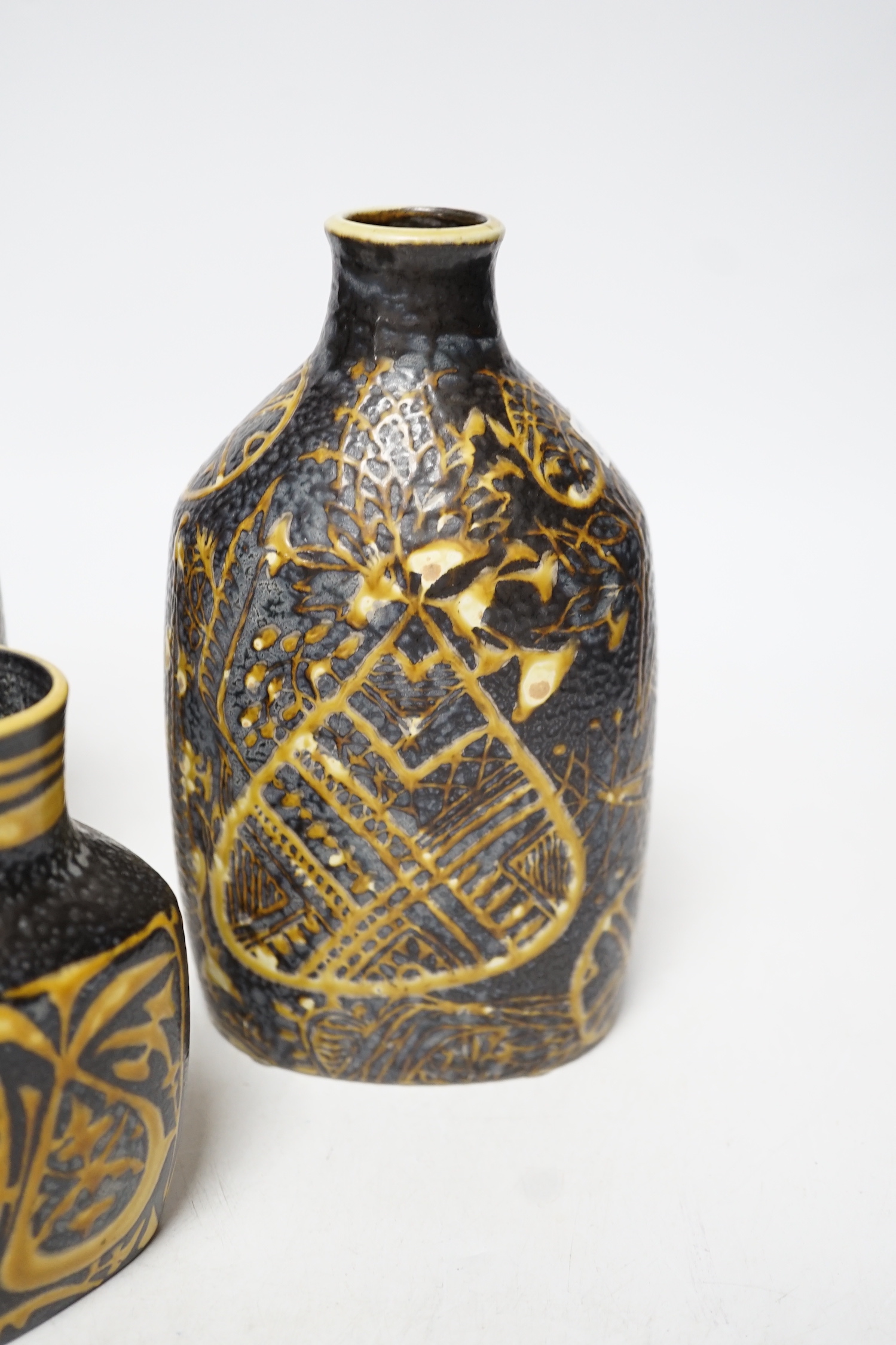A pair of Royal Copenhagen brown and yellow decorated fajance vases marked 3208 on base and a similar bird decorated squat vase marked 3361 on base, pair of vases 18cm high